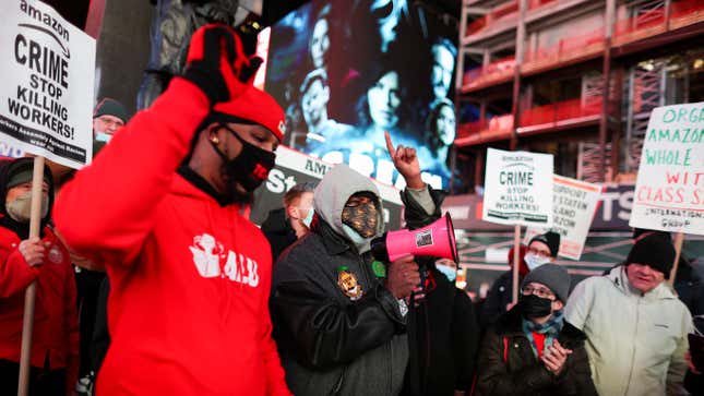 Amazon workers holding signs protest in Times Square