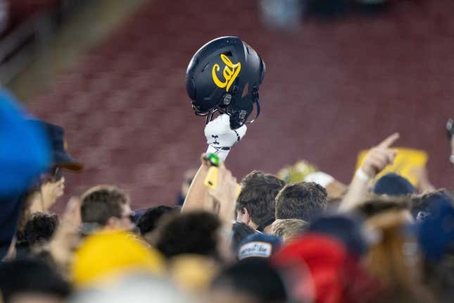 Nov 20, 2021; Stanford, California, USA; California Golden Bears helmet is raised into the air amongst fans after defeating the Stanford Cardinal at Stanford Stadium.