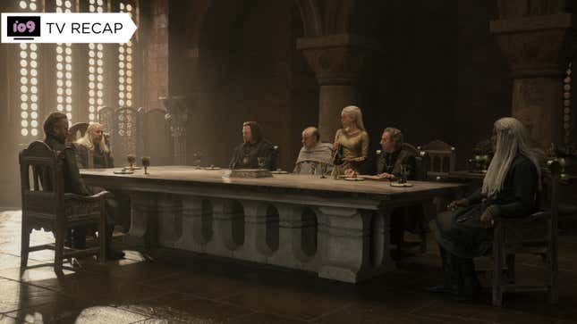 King Viserys sits at the head of a long table with the members of his Small Council on the side.