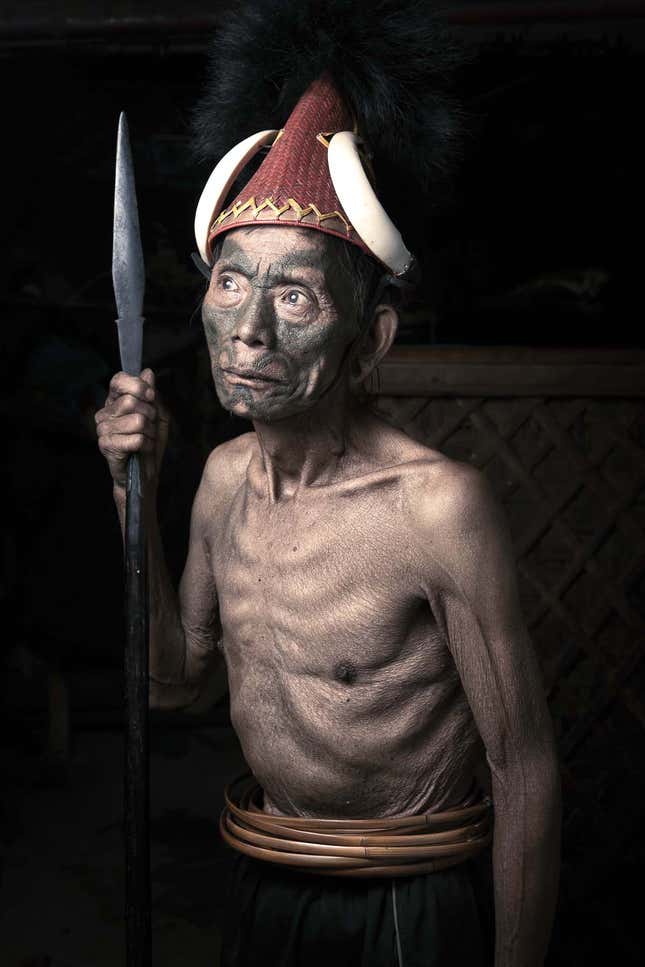Manchak Wankongpa, 80, wears a hat decorated with two tusks of a wild boar.