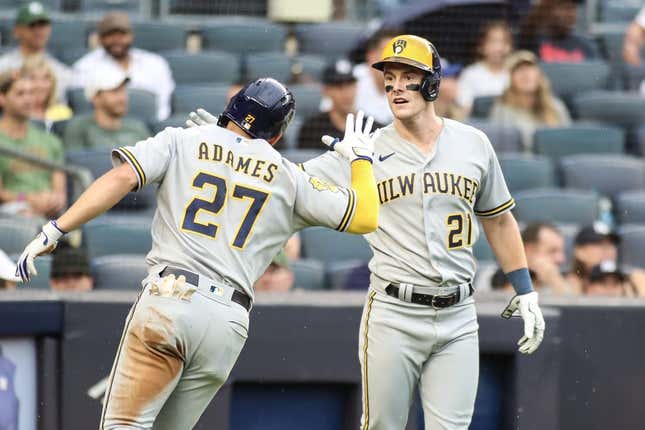 Sep 9, 2023; Bronx, New York, USA;  Milwaukee Brewers shortstop Willy Adames (27) is greeted by right fielder Mark Canha (21) after hitting an RBI triple and scoring on an error in the fourth inning against the New York Yankees at Yankee Stadium.