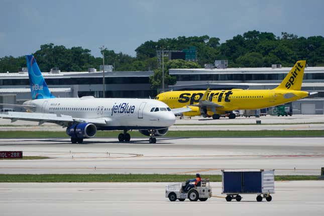 FILE - A JetBlue Airways Airbus A320, left, passes a Spirit Airlines Airbus A320 as it taxis on the runway, July 7, 2022, at the Fort Lauderdale-Hollywood International Airport in Fort Lauderdale, Fla. JetBlue Airways is making another move to try to save its proposed purchase of Spirit Airlines. JetBlue said Monday, Sept. 11, 2023 it reached a deal to turn over Spirit&#39;s gates at airports in Boston and Newark, New Jersey, to low-cost carrier Allegiant. (AP Photo/Wilfredo Lee, File)