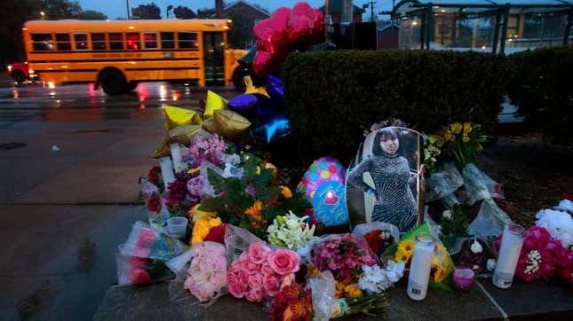 A photo of Alexandria Bell rests at the scene of a growing floral memorial to the victims of a school shooting at Central Visual &amp; Performing Arts High School, Tuesday, Oct. 25, 2022, in St. Louis. Bell and teacher Jean Kuczka were killed, along with the gunman, in Monday’s shooting.