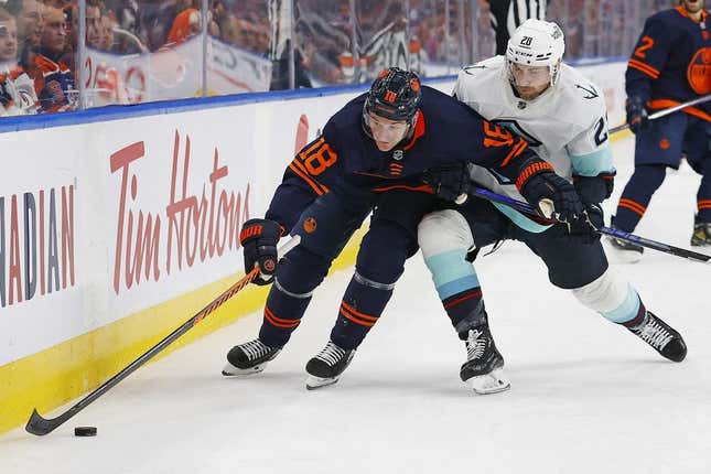 Jan 17, 2023; Edmonton, Alberta, CAN; Edmonton Oilers forward Zach Hyman (18) protects the puck from Seattle Kraken defensemen Carson Soucy (28) during the third period at Rogers Place.