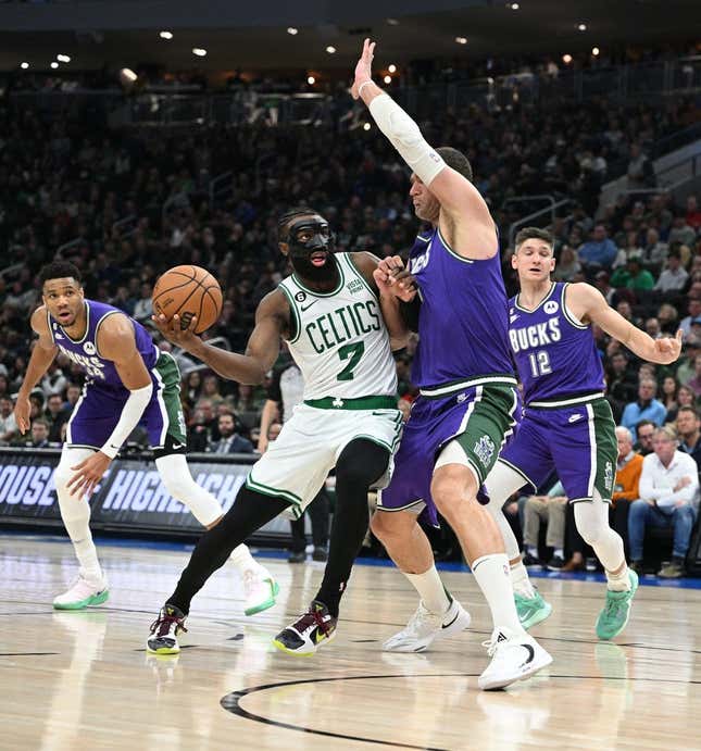 Mar 30, 2023; Milwaukee, Wisconsin, USA; Boston Celtics guard Jaylen Brown (7) drives to the basket against Milwaukee Bucks center Brook Lopez (11) at Fiserv Forum.
