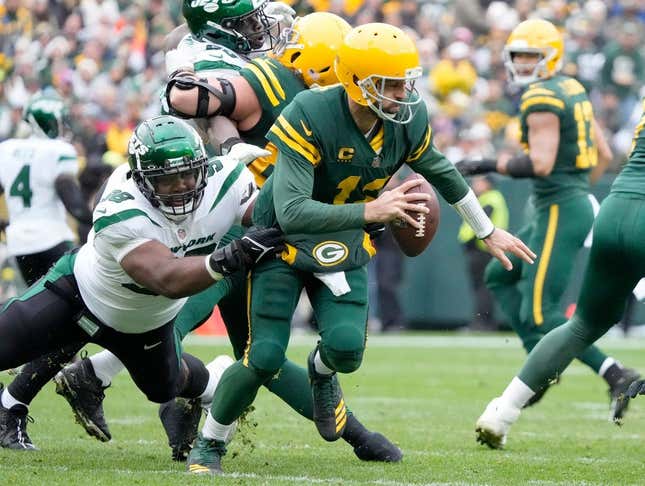 Packers quarterback Aaron Rodgers tries to escape Jets defensive tackle Sheldon Rankins during the first half of their game at Lambeau Field in Green Bay on Oct. 16, 2022.

Syndication Journal Sentinel