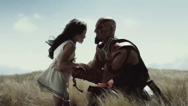 Kratos is seen picking up Calliope in a field while wearing Spartan armor.