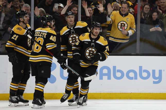 Mar 2, 2023; Boston, Massachusetts, USA; Boston Bruins defenseman Connor Clifton (75) is congratulated by teammates after scoring against the Buffalo Sabres during the third period at TD Garden.