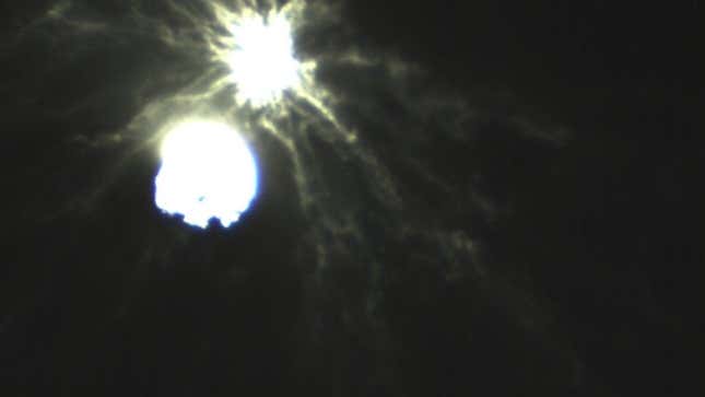 A zoomed-in view of the impact shows complex strands of ejecta stirred up the impact.