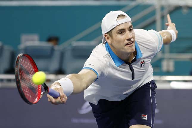 Mar 22, 2023; Miami, Florida, US; John Isner (USA) hits a volley against Emilio Nara (USA) (not pictured) on day three of the Miami Open at Hard Rock Stadium.