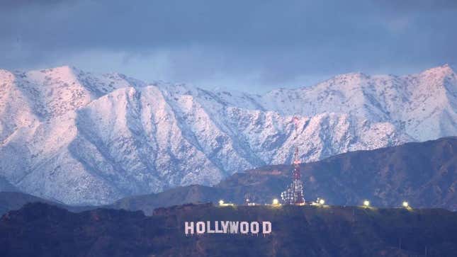 The Hollywood sign stands in front of snow-covered mountains after another winter storm hit Southern California on March 01, 2023 in Los Angeles, California.