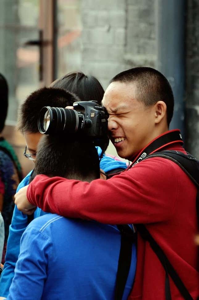boy taking photo on someones head