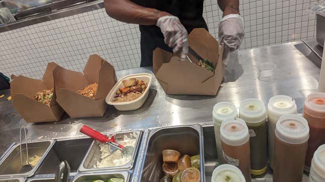Sweetgreen employee prepares salads