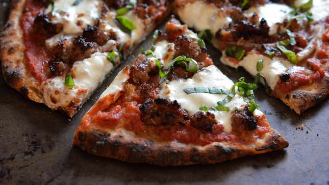 A crispy and delicious-looking slice of pizza on a wooden countertop