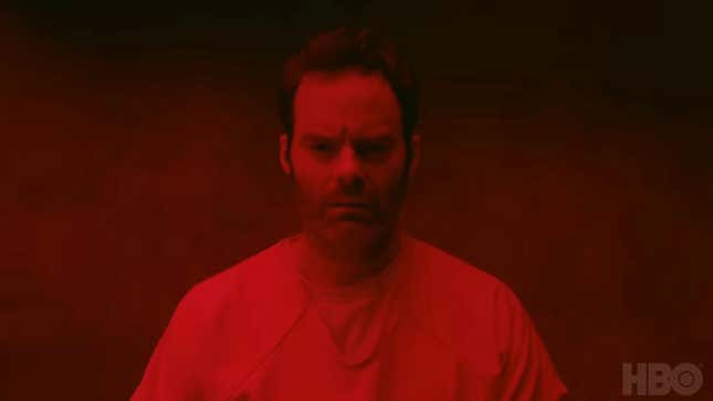 Bill Hader's Barry furrows his brow while looking into the camera; the scene is tinged with red light