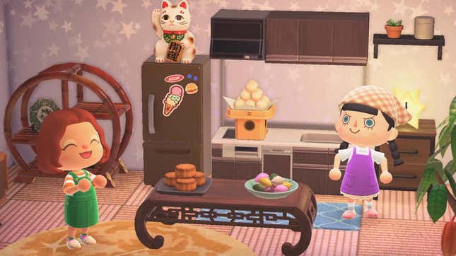 Two Animal Crossing players smile and stand in their kitchen.