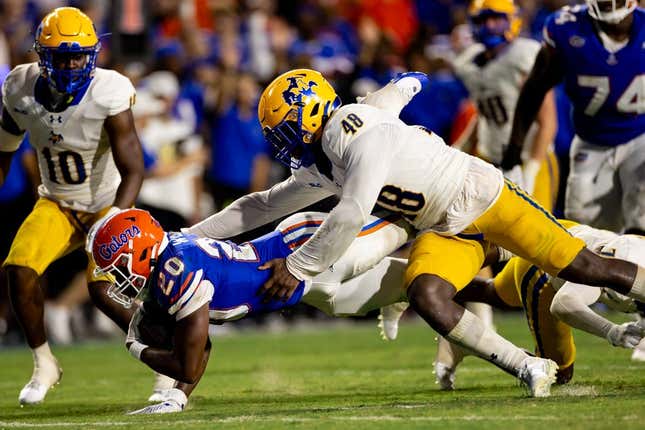September 9, 2023;  Gainesville, Florida, USA;  Florida Gators running back Treyaun Webb (20) stretches for a first down that is tackled by McNeese State Cowboys linebacker Micah Davey (48) during the second half at Ben Hill Griffin Stadium.
