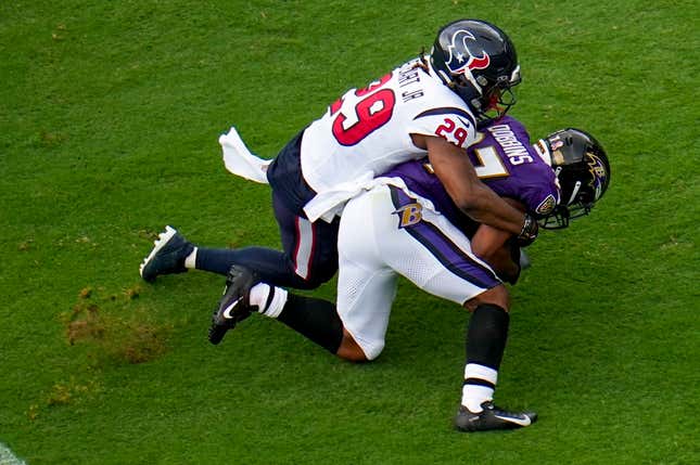 Baltimore Ravens’ J.K. Dobbins is stopped by Houston Texans’ M.J. Stewart after an NFL football game Sunday, Sept. 10, 2023, in Baltimore. The Ravens won 25-9.