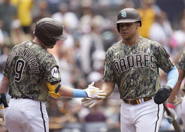 Jun 18, 2023; San Diego, California, USA;  San Diego Padres left fielder Juan Soto (right) is congratulated by first baseman Jake Cronenworth (9) after scoring against the Tampa Bay Rays during the third inning at Petco Park.