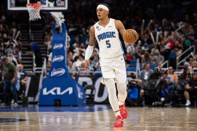 Apr 4, 2023; Orlando, Florida, USA; Orlando Magic forward Paolo Banchero (5) dribbles the ball against the Cleveland Cavaliers in the third quarter at Amway Center.