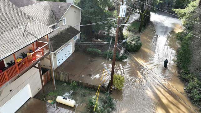 In an aerial view, a resident walks through a flooded neighborhood on January 09, 2023 in Guerneville, California. 
