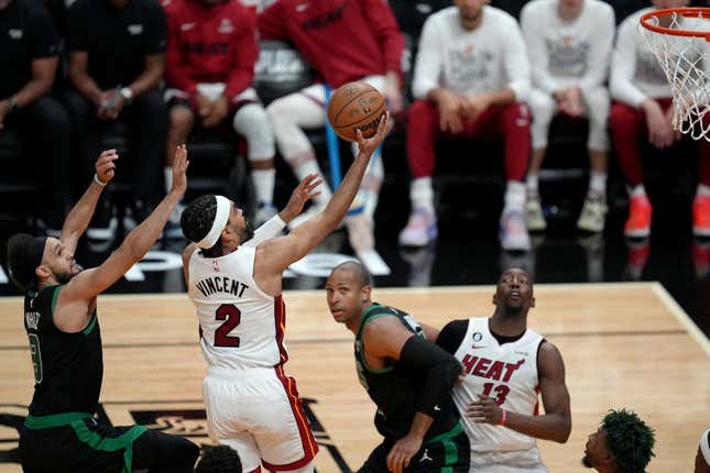 May 21, 2023;  Miami, Florida, USA;  Miami Heat guard Gabe Vincent (2) shoots against Boston Celtics guard Derrick White (9) during the second half of Game 3 of the East Finals of the 2023 NBA Playoffs at Kaseya Center.