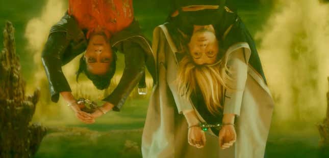 Yaz (Mandip Gill) and the Doctor (Jodie Whittaker) hang upside down, handcuffed, in a scene from Doctor Who: Flux.
