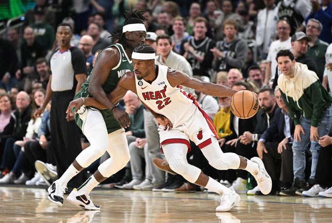Apr 26, 2023; Milwaukee, Wisconsin, USA; Miami Heat forward Jimmy Butler (22) drives against Milwaukee Bucks guard Jrue Holiday (21) during game five of the 2023 NBA Playoffs at Fiserv Forum.