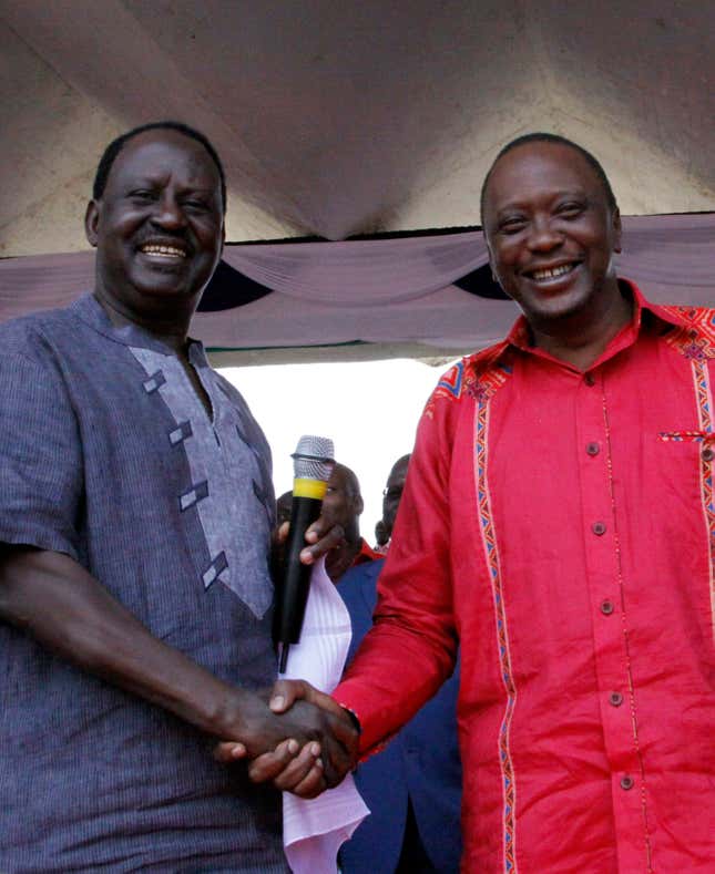 Raila Odinga, left, shakes hands with rival Uhuru Kenyatta, during a Nairobi election rally, in Feb. 2013.