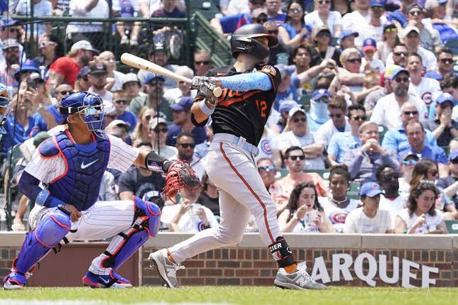 Jun 18, 2023; Chicago, Illinois, USA; Baltimore Orioles second baseman Adam Frazier (12) hits an RBI single against the Chicago Cubs during the sixth inning at Wrigley Field.