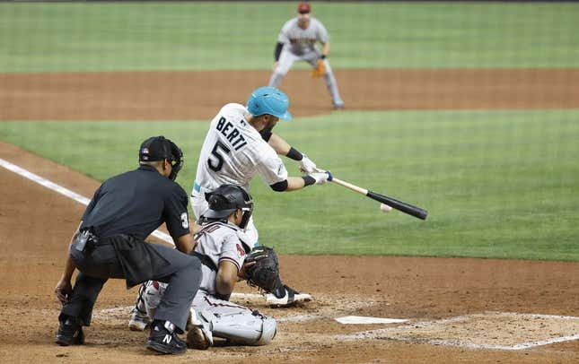 Apr 14, 2023; Miami, Florida, USA; Miami Marlins third baseman Jon Berti (5) doubles against the Arizona Diamondbacks during the fifth inning at loanDepot Park.