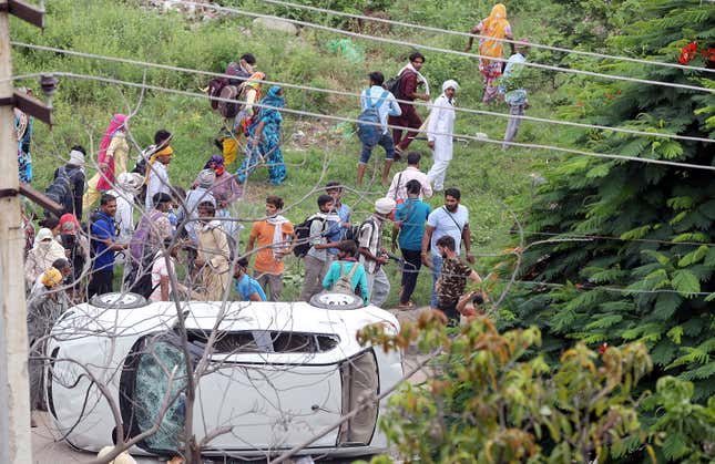 Vehicles being damaged by suspected Dera Sacha Sauda sect members in Panchkula, India, Aug. 25.