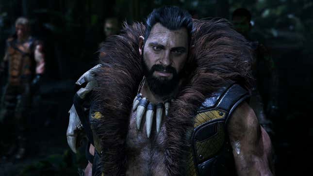 Kraven, the villain in Marvel's Spider-Man 2, wearing a fur-lined vest and animal tooth necklace. 