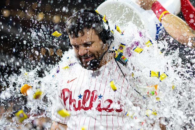 Jun 9, 2023; Philadelphia, Pennsylvania, USA; Philadelphia Phillies left fielder Kyle Schwarber (12) is doused by a cooler of water and bubble gum after hitting a walk off game winning home run against the Los Angeles Dodgers during the ninth inning at Citizens Bank Park.
