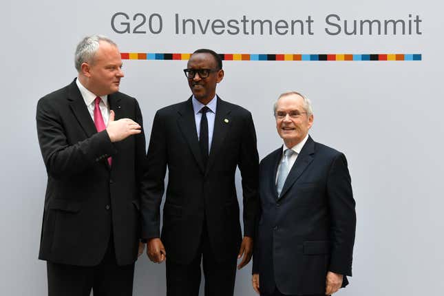 FILE- Stefan Liebing, left, chairman of the German African Business Association (Afrika-Verein der deutschen Wirtschaft), and Heinz-Walter Grosse, right, chairman of the Sub-Saharan Africa Initiative of German Business (SAFRI), pose with Rwanda&#39;s President Paul Kagame, center, as he arrives to attend the &quot;G20 Investment Summit - German Business and the CwA Countries 2019&quot; on the sidelines of a Compact with Africa (CwA) in Berlin on November 19, 2019. The G20 group of the world&#39;s leading economies is welcoming the African Union as a permanent member, a powerful acknowledgement of the continent of more than 1.3 billion people as its countries seek a more important role on the global stage. (John MacDougall/Pool via AP, File)