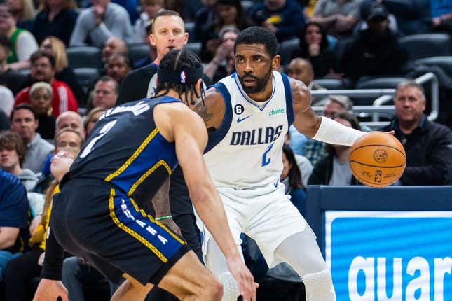 Mar 27, 2023; Indianapolis, Indiana, USA; Dallas Mavericks guard Kyrie Irving (2) dribbles the ball while Indiana Pacers guard Andrew Nembhard (2) defends in the first quarter at Gainbridge Fieldhouse.