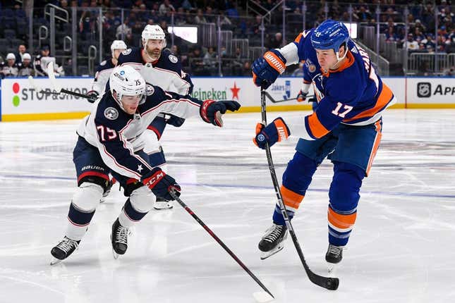 Dec 29, 2022; Elmont, New York, USA; New York Islanders left wing Matt Martin (17) attempts a shot defended by Columbus Blue Jackets defenseman Tim Berni (75) during the second period at UBS Arena.