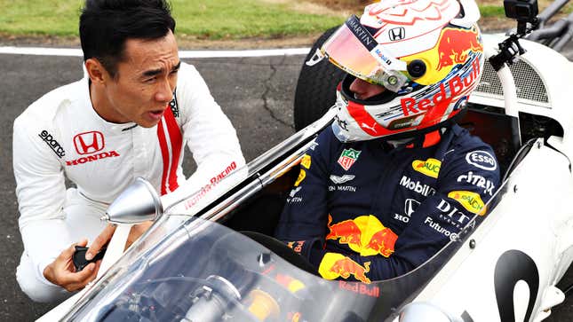 Takuma Sato, left, talks with Max Verstappen before Verstappen drives the Honda RA272 ahead of the 2019 Japanese Grand Prix.