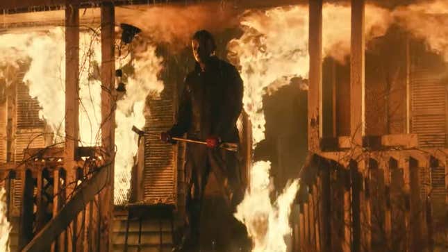 Michael Myers stands on the burning porch of Laurie Strode's house in Halloween Kills.