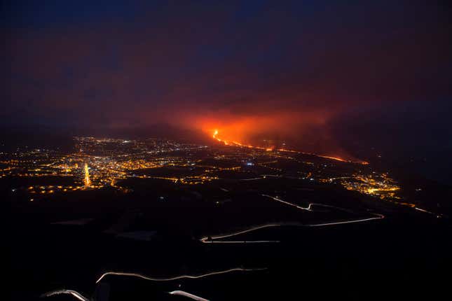  The Cumbre Vieja volcano, pictured from Tijarafe, spews lava, ash, and smoke, on the Canary Island of La Palma, at night on October 10, 2021.