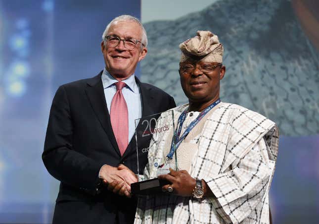 Oba Otudeko (R) founder of Honeywell Group receives the CEO of the Year award from Jay Ireland (L) CEO of General Electric Africa during the Africa CEO Forum Awards
