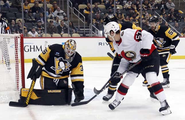 Mar 20, 2023; Pittsburgh, Pennsylvania, USA;  Pittsburgh Penguins goaltender Tristan Jarry (35) makes a save against Ottawa Senators center Shane Pinto (57) during the first period at PPG Paints Arena. Ottawa won 2-1.