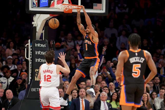 Mar 1, 2023; New York, New York, USA; New York Knicks forward Obi Toppin (1) dunks against Brooklyn Nets forward Joe Harris (12) during the second quarter at Madison Square Garden.