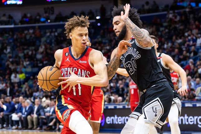 Mar 21, 2023; New Orleans, Louisiana, USA; New Orleans Pelicans guard Dyson Daniels (11) dribbles against San Antonio Spurs forward Julian Champagnie (30)  during the second half at Smoothie King Center.
