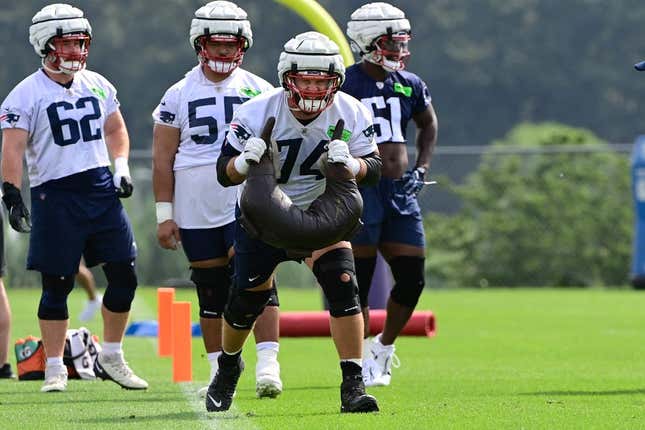 Jul 27, 2023; Foxborough, MA, USA; New England Patriots offensive tackle Riley Reiff (74) works with a weight bag during training camp at Gillette Stadium.