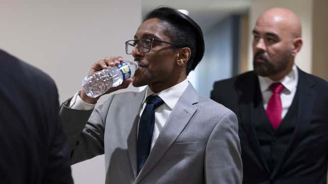 WASHINGTON, DC - DECEMBER 09: Stop the Steal organizer Ali Alexander takes a sip of water as he returns to a conference room for a deposition meeting on Capitol Hill with the House select committee investigating the January 6th attack on December 09, 2021 in Washington, DC. Members of the committee and staff members are meeting with Alexander as well as Government official Kash Patel, who both say they are cooperating with the committee investigation. (Photo by Anna Moneymaker/Getty Images)