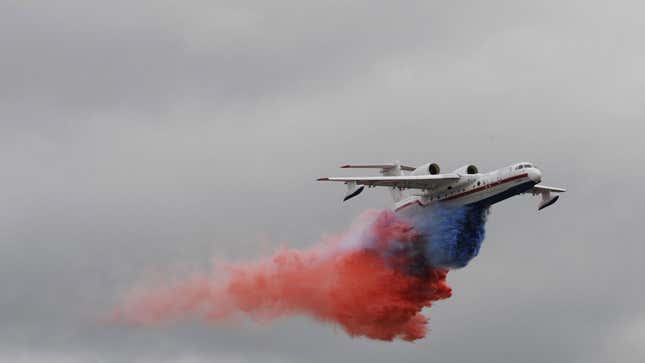 A photo of a Russian plane dropping red, white and blue water. 
