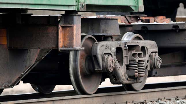 A photo of train wheels on a Norfolk Southern carriage.