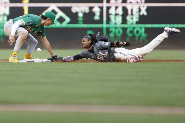 Aug 12, 2023; Washington, District of Columbia, USA; Washington Nationals shortstop CJ Abrams (5) steals second base ahead of an attempted tag by Oakland Athletics second baseman Zack Gelof (20) during the first inning at Nationals Park.