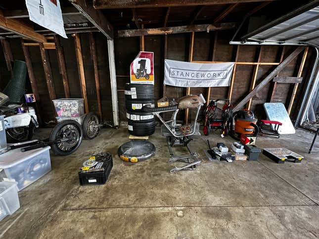 Motorcycle parts being organized by group on a garage floor